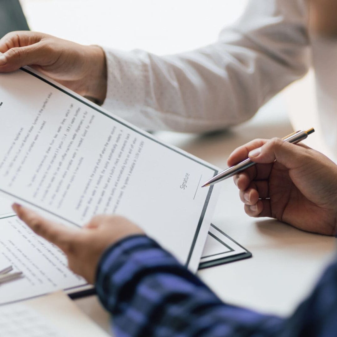 Person signing an insurance document.