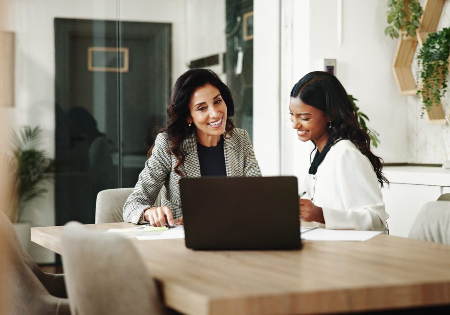 Two women working together in an office.